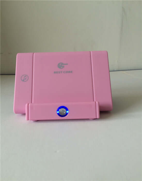 Smart Bluetooth Speaker in pink color with illuminated button, showcasing modern design and compact size.