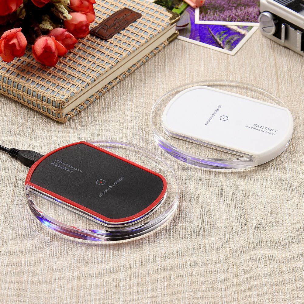 Wireless charger wireless receiver displayed in black and white design on a table with flowers.