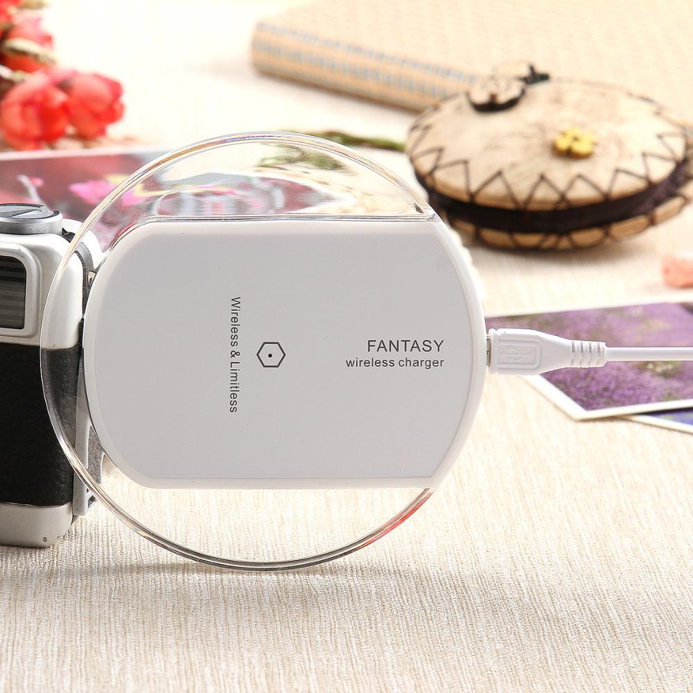 Wireless charger wireless receiver on a table with photography equipment and decorative items.