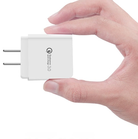 Fast charge charger held in hand, compact design, ideal for travel and quick charging of mobile phones.