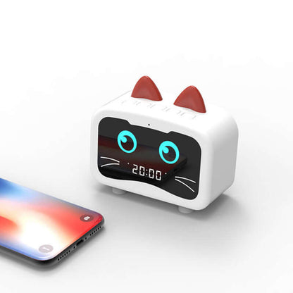 Cute cat-shaped wireless Bluetooth speaker next to a smartphone displaying the time.