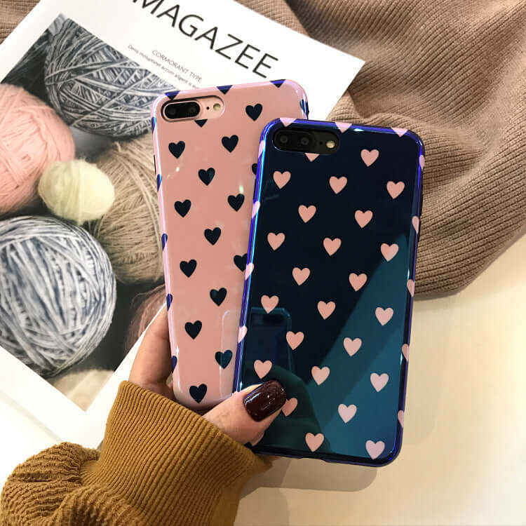 Two Blu-ray love heart phone cases in pink and blue with heart patterns, showcasing stylish and protective soft silicone design.