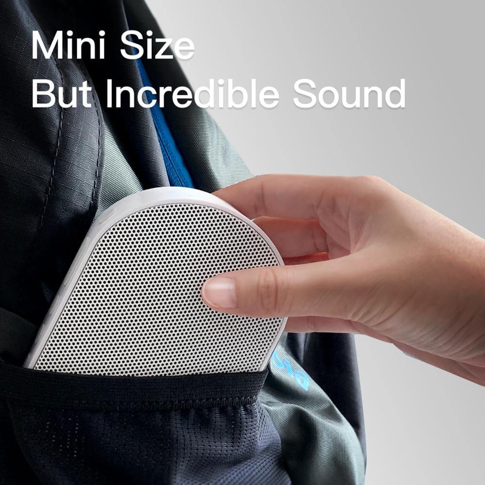 Hand inserting a Bluetooth stereo smart speaker into a backpack, showcasing its mini size and incredible sound.