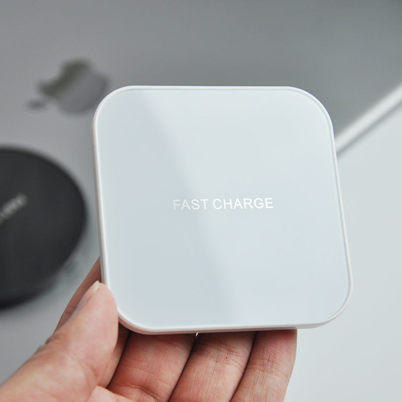 Earphone wireless charger in hand, showcasing a square fast charge design for wireless earphone charging.