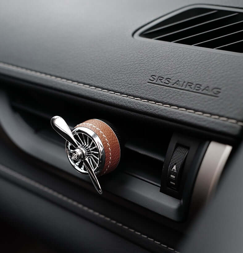Car sesame oil diffuser attached to a car air vent for freshening up the car air.