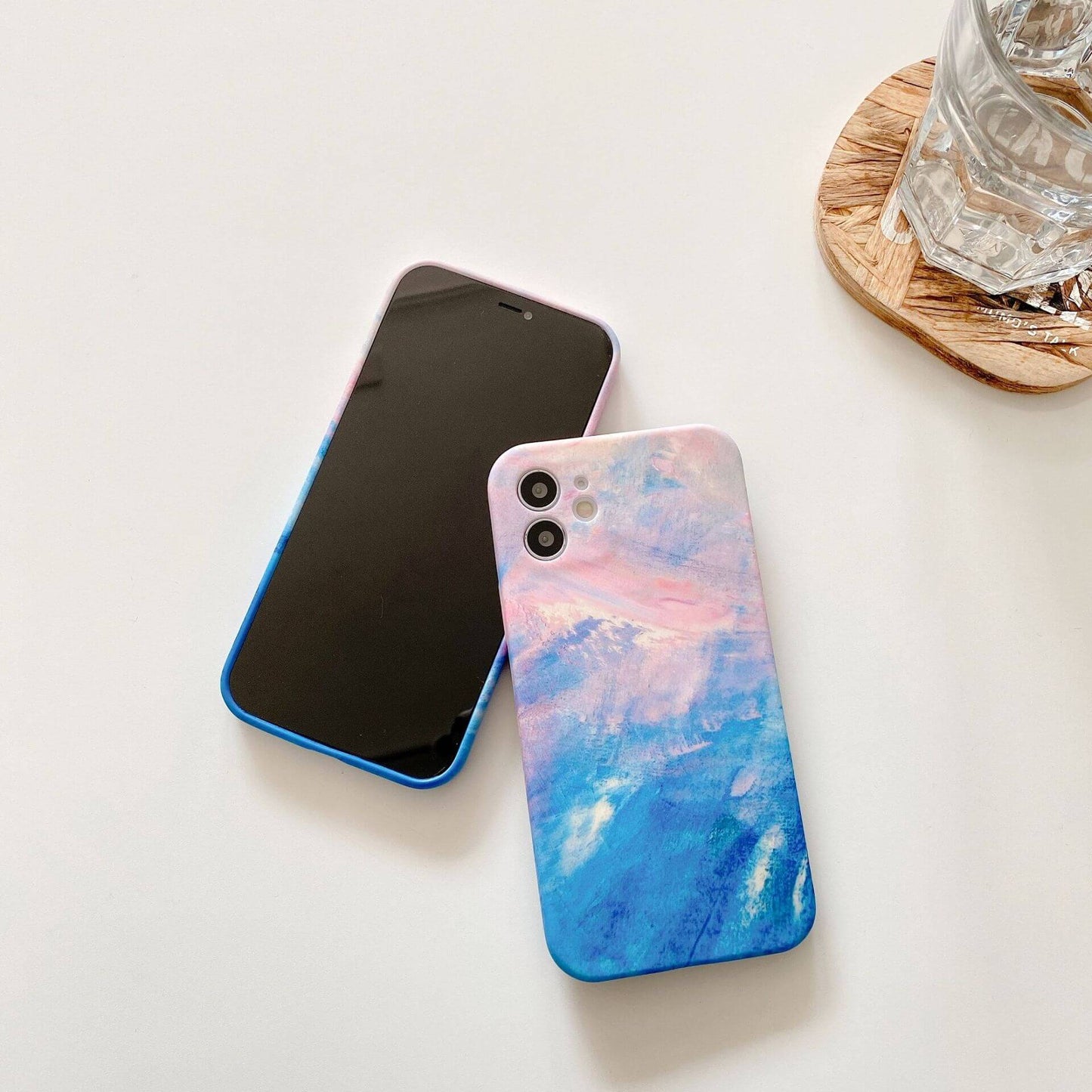 Artistic graffiti phone case showcasing vibrant pink and blue colors on a smartphone.