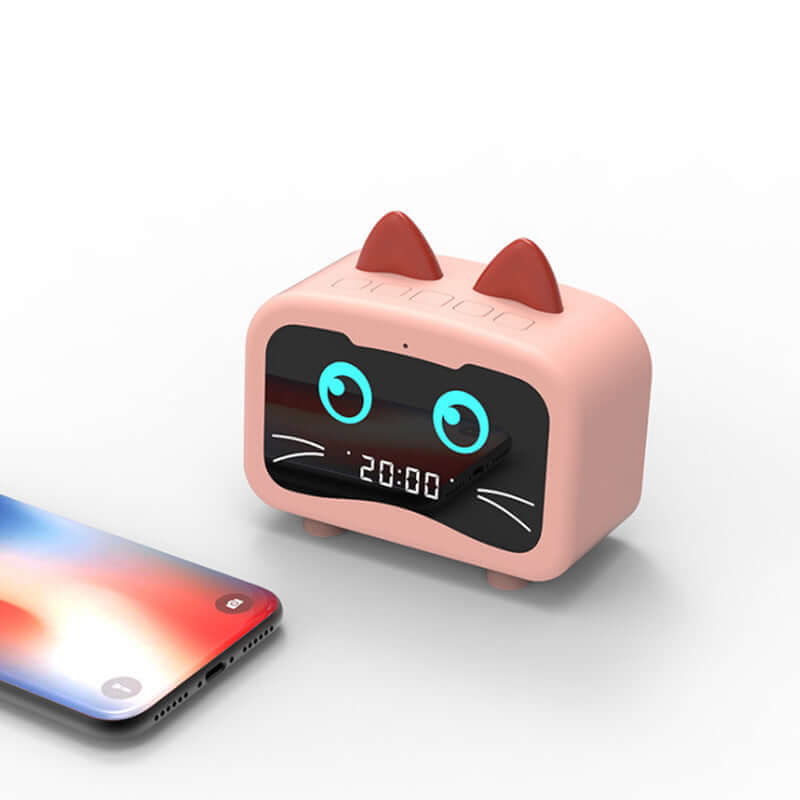 Wireless Bluetooth speaker in a cute cat design with digital display next to a smartphone.