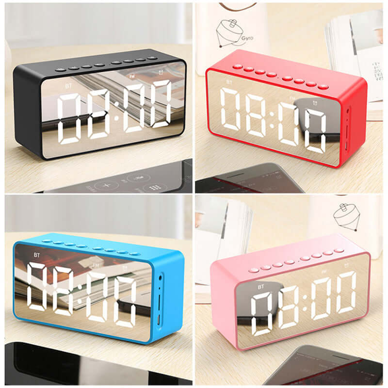 Alarm clock bluetooth speaker in black, pink, blue with large mirrored display and buttons.