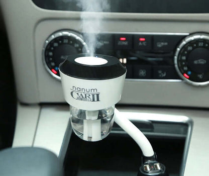 Car Aromatherapy Diffuser 50ml in vehicle interior with mist emitting from the top.