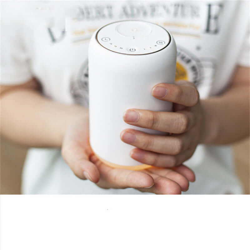 Handy Car Waterless Diffuser Desktop Humidifier held in hands with control buttons on top.