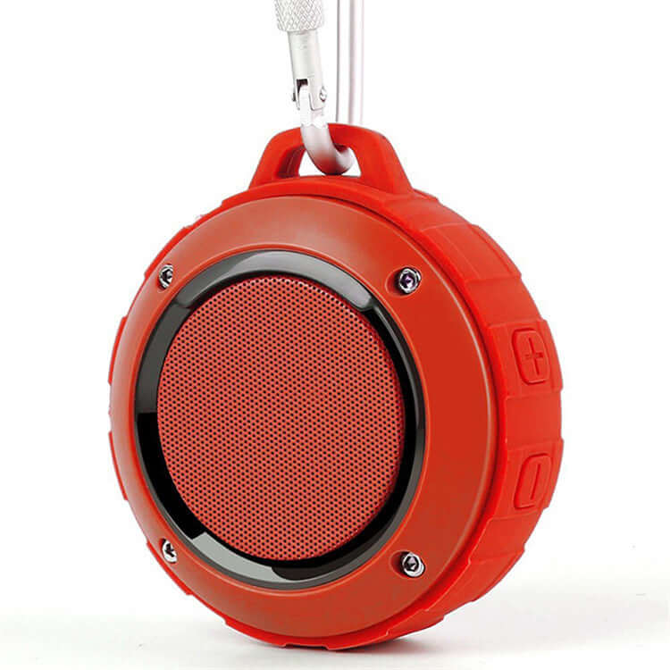 Waterproof Bluetooth speaker in vibrant orange color with durable shell and carabiner for outdoor use.