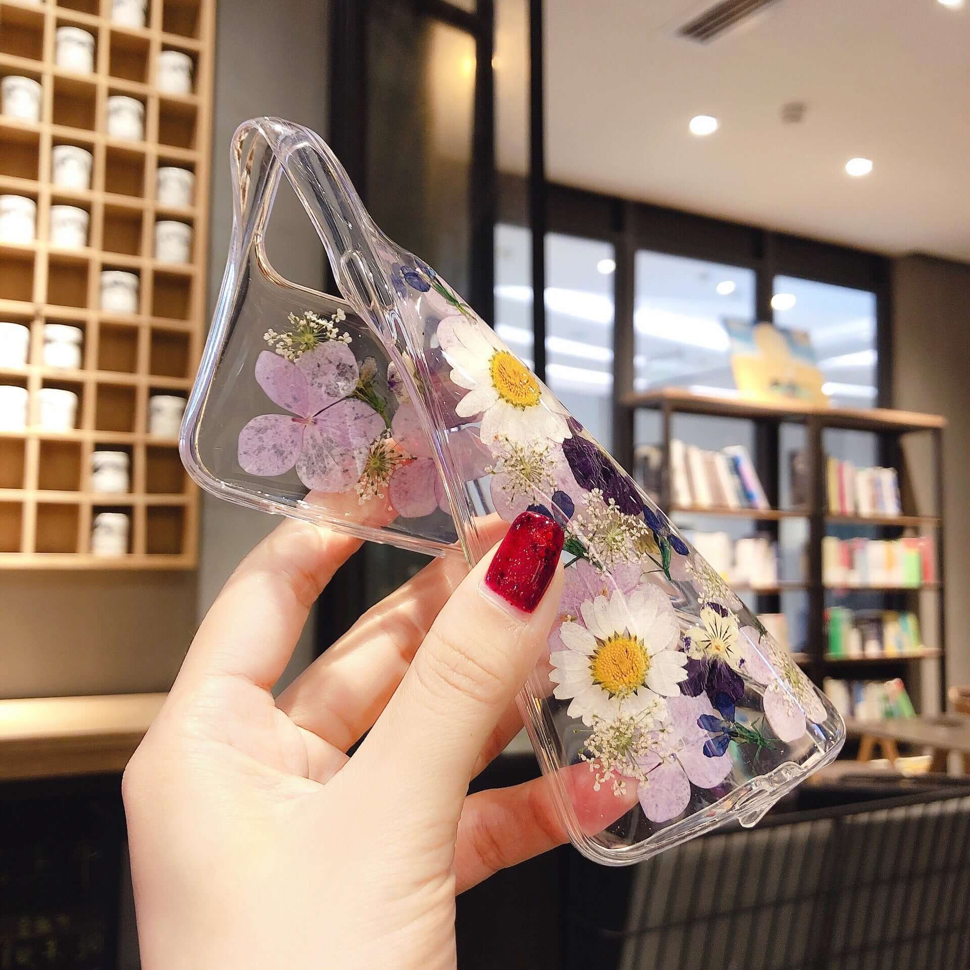 Preserved flower phone cases featuring vibrant floral designs and protective epoxy for various iPhone models.