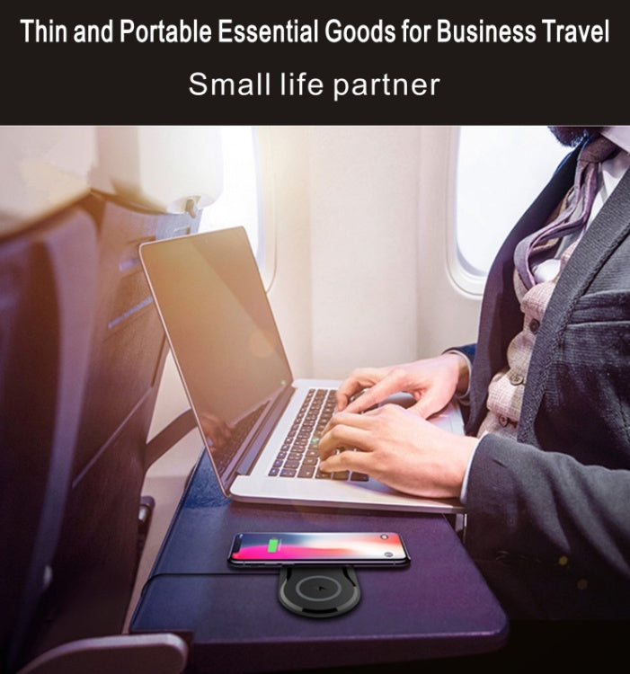 Wireless Charger on a travel table with a laptop and smartphone, ideal for business travel and charging convenience.