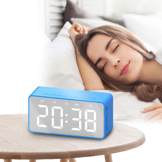 Alarm clock bluetooth speaker with large display next to a woman sleeping comfortably.