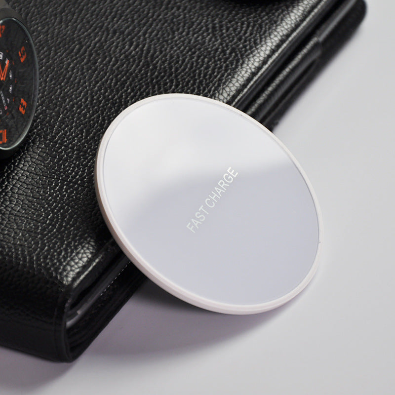 Earphone wireless charger on a black wallet, featuring a fast charge design with a sleek circular style.