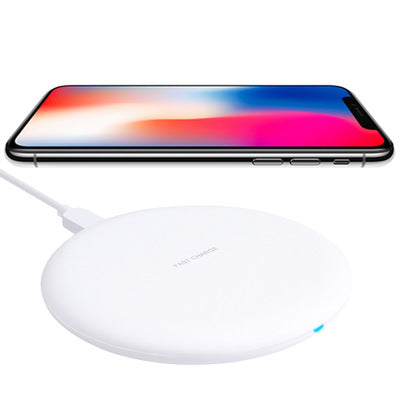 Wireless charger with a smartphone on top, showcasing wireless charging technology.