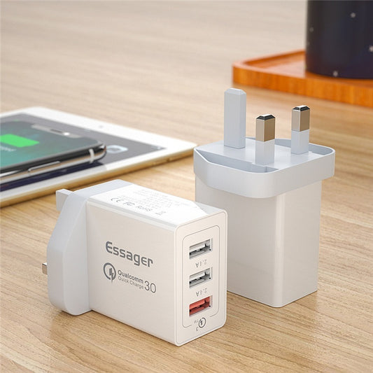 Three-Port USB Fast Charge 30WQC30 Mobile Phone Charger displayed on a table next to a smartphone.