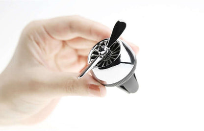 Car sesame oil diffuser held in hand, stylish design for car air freshening and decor.
