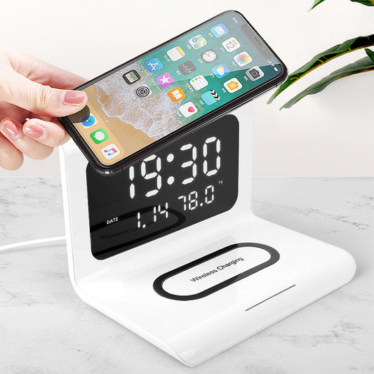 Multifunctional wireless charger with clock display and phone charging function on a white stand.