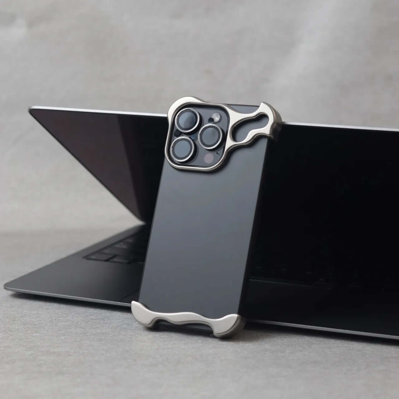 Zinc alloy iPhone 15 Pro Max case showcased on a laptop, offering stylish and durable protection.