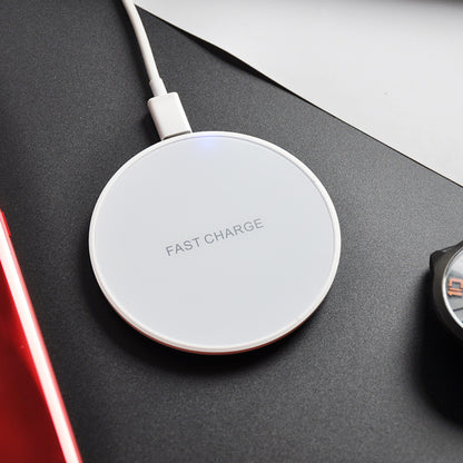 Earphone wireless charger with fast charge technology on a sleek black surface next to a smartphone and watch.
