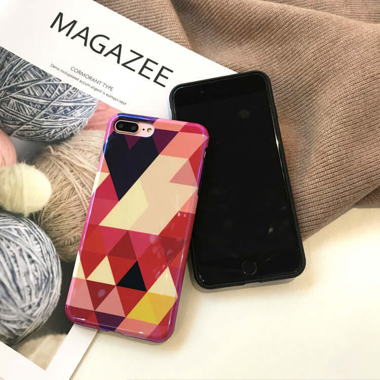 Blu-ray love heart phone case displayed alongside a black smartphone and yarn, showcasing vibrant geometric design.