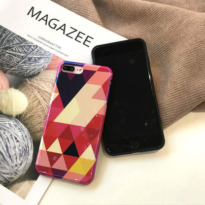 Blu-ray love heart phone case displayed alongside a black smartphone and yarn, showcasing vibrant geometric design.