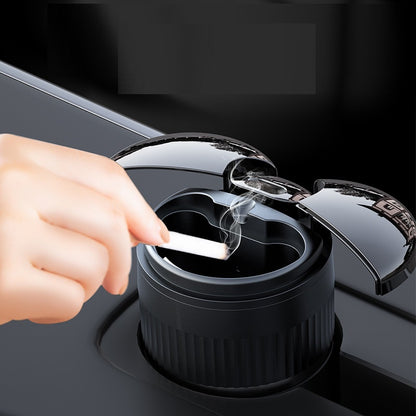 Multi-functional Creative Smart Car Ashtray With Lid in use, featuring a hand placing a cigarette into the ashtray.