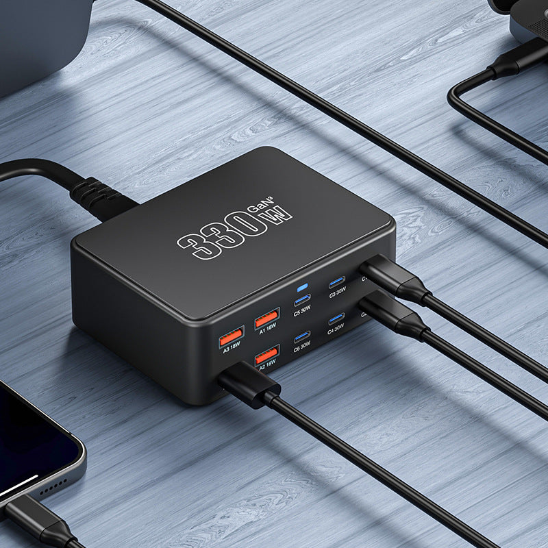 330W Super Fast Charge Porous Charger with multiple output ports on a wooden surface.