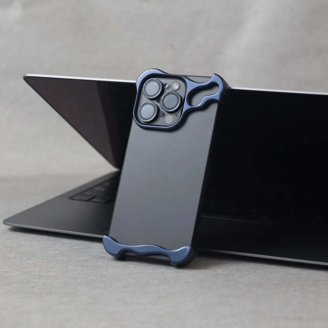 Zinc alloy iPhone 15 Pro Max case displayed on a laptop, showcasing its sleek design and premium protection.