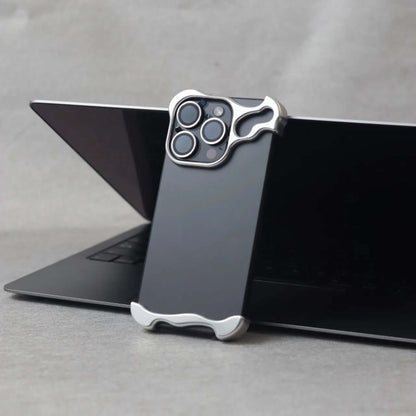 Zinc alloy iPhone 15 Pro Max case displayed on a laptop, highlighting its protective design and sleek aesthetics.
