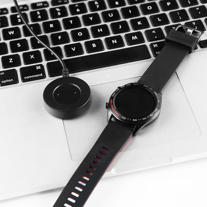 Watch Integrated Charging Cable and smartwatch on a laptop keyboard, showcasing convenient charging.