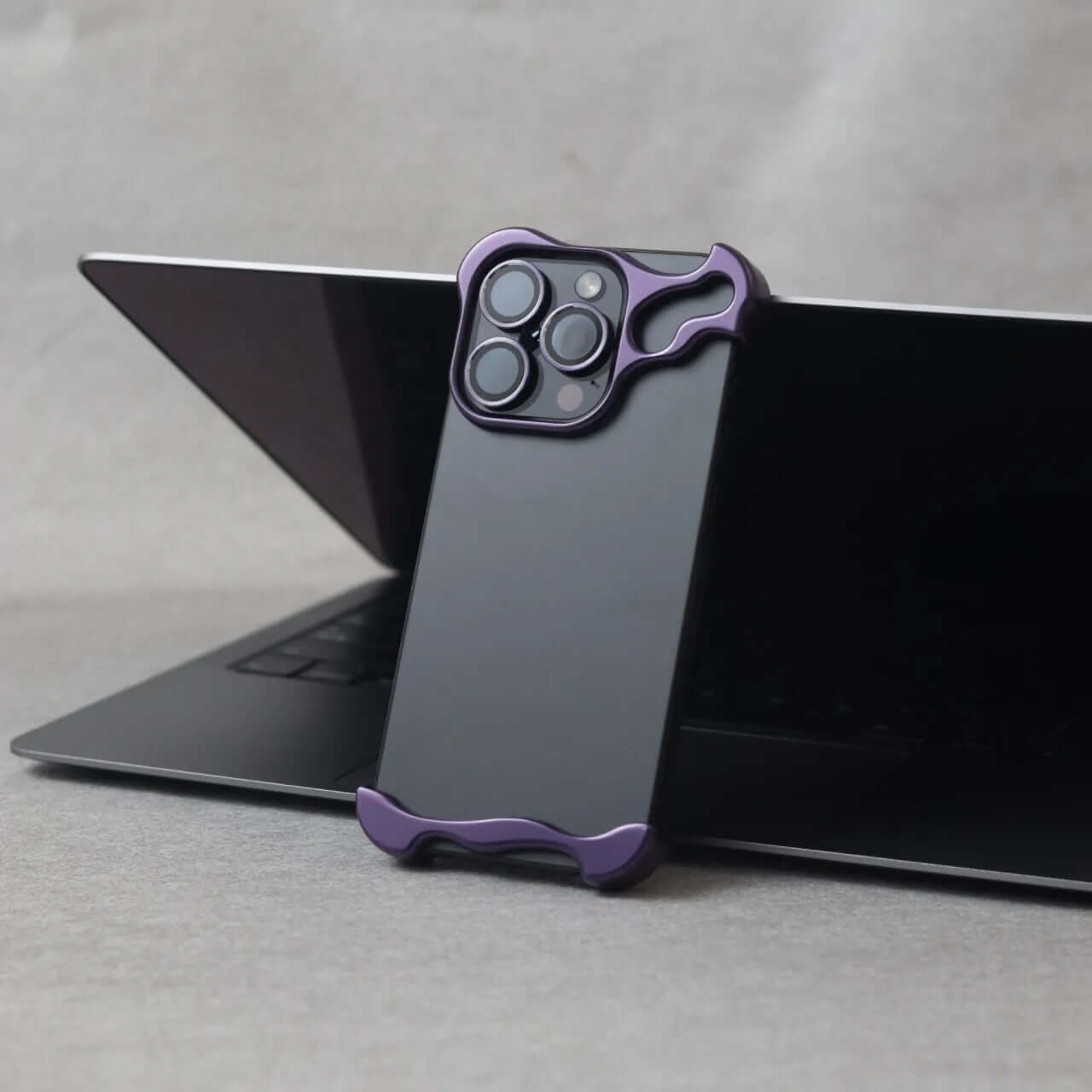 Zinc alloy iPhone 15 Pro Max case shown on a laptop, combining style and protection.