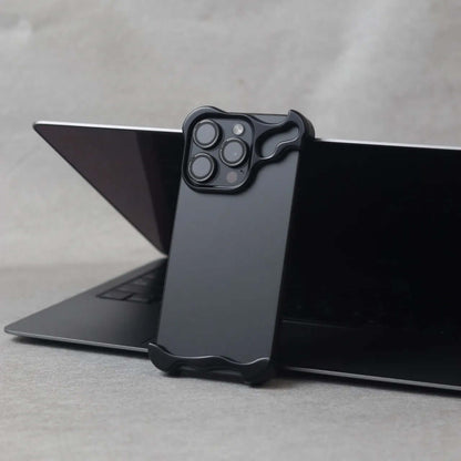 Zinc alloy iPhone 15 Pro Max case resting on a laptop, showcasing its sleek and protective design.