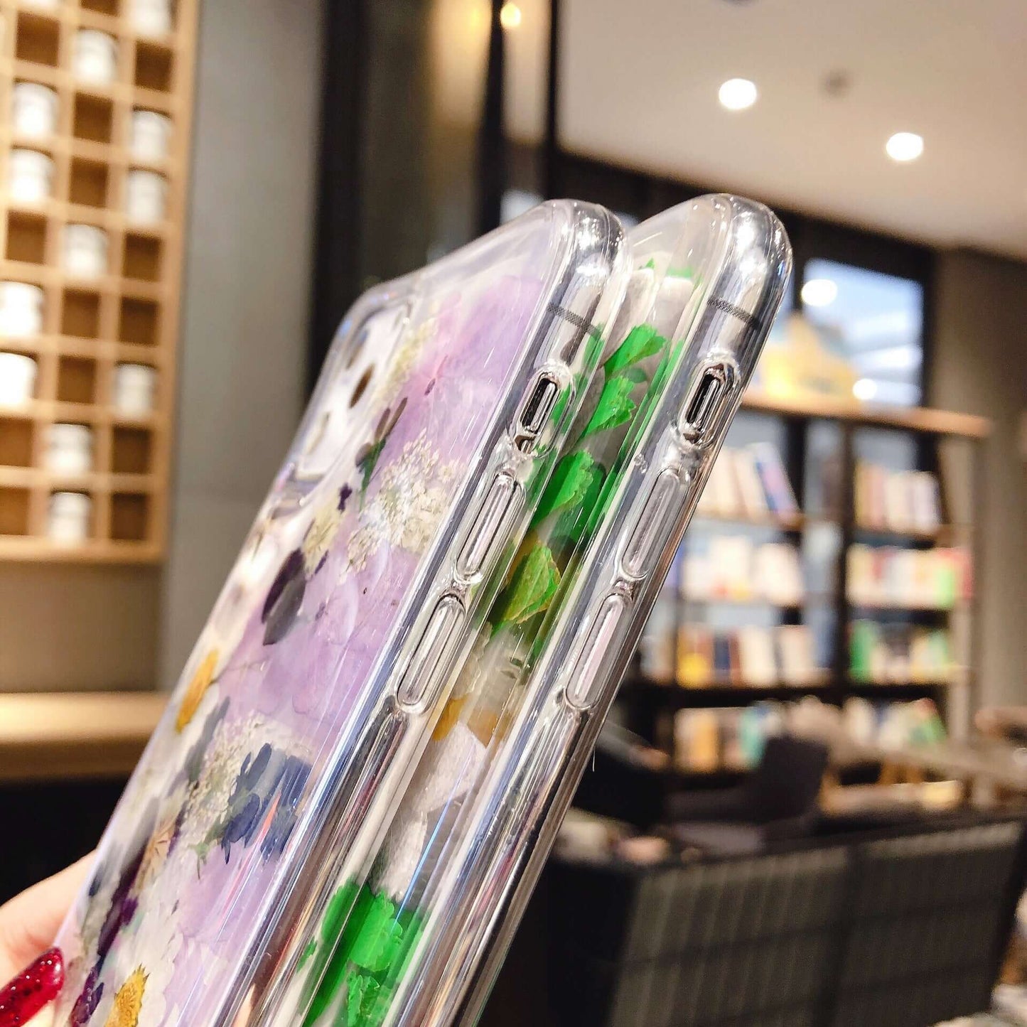 Close-up of preserved flower phone cases showcasing intricate floral designs and modern protection.